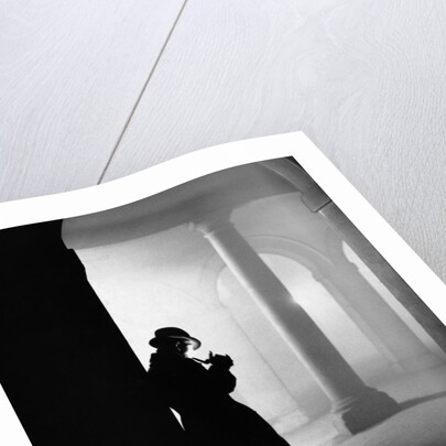 Silhouette of Man Lighting Pipe by Anonymous
