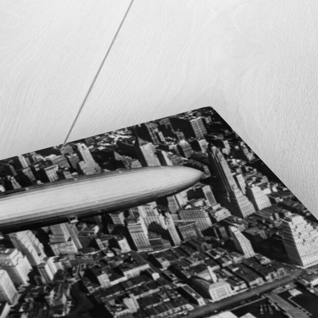 The German airship, the Hindenburg, above Manhattan, New York in 1936, on its way to its berth at Lakehurst , New Jersey, the same place where it inexplicably burst into flames the next year. by Anonymous