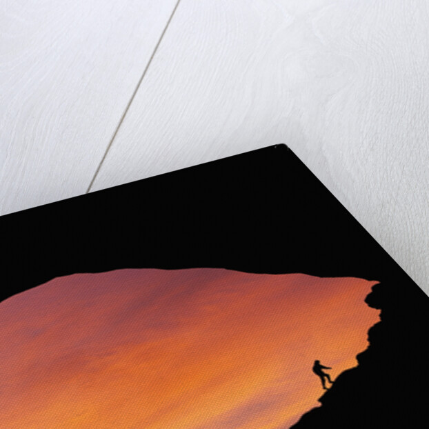 Hiker Climbing a Natural Arch in Utah by Anonymous