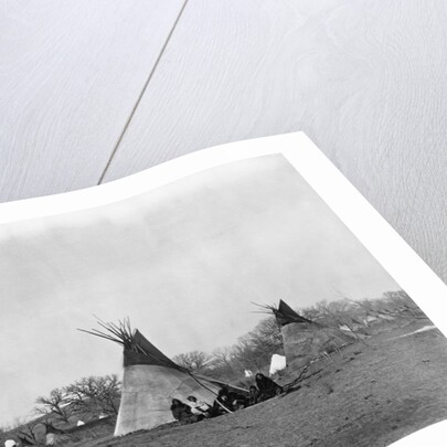 A Native American Family Sits Outside Their Teepee by Corbis