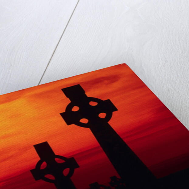 Celtic Crosses Silhouetted at Sunset by Corbis