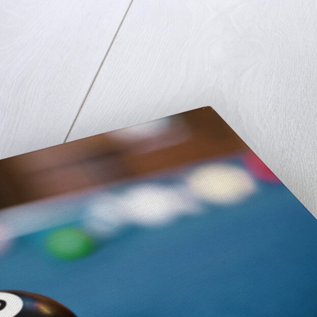 Eight ball on pool table by Anonymous