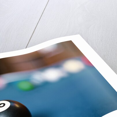 Eight ball on pool table by Anonymous