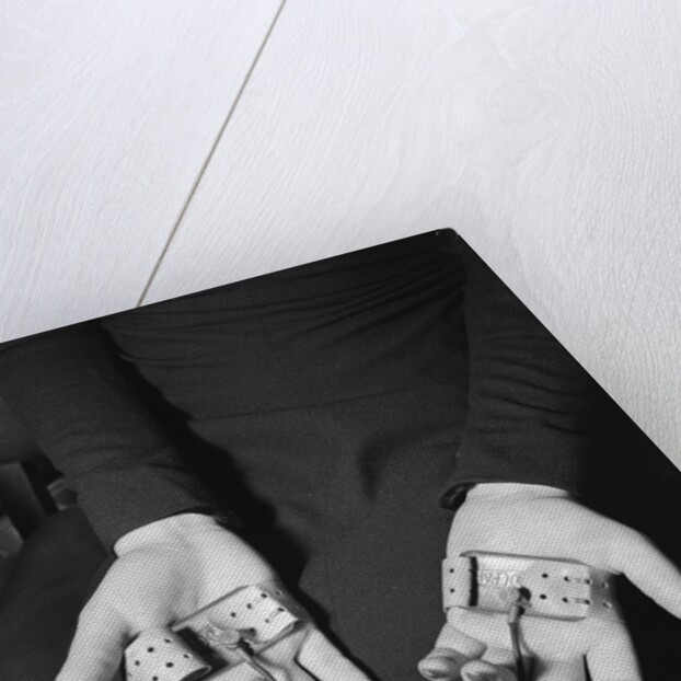 Pair of Hands Wearing Lie Detector Device by Anonymous