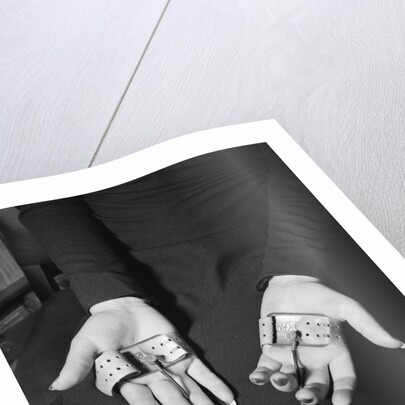 Pair of Hands Wearing Lie Detector Device by Anonymous