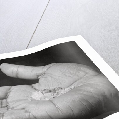 Close up of Hand Holding Diamonds by Anonymous
