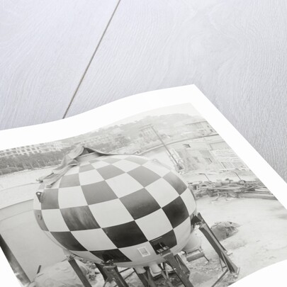 Checkered Steel Sphere Resting on Platform by Anonymous