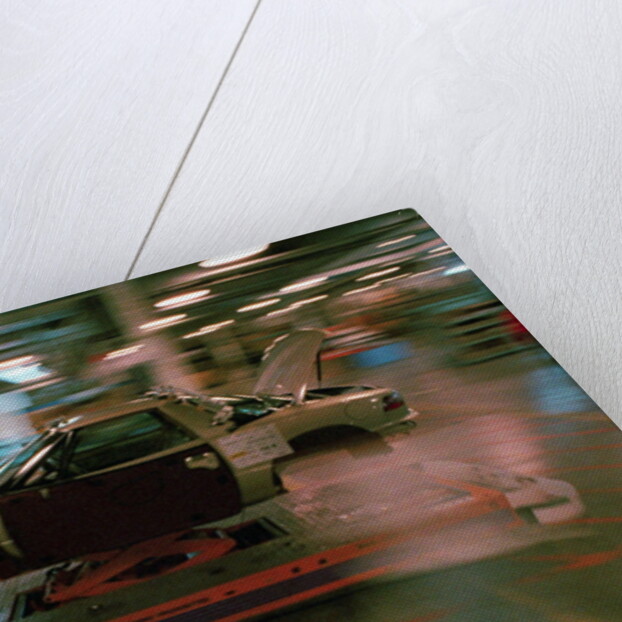 Partially Assembled Car Moving Through Work Station by Anonymous