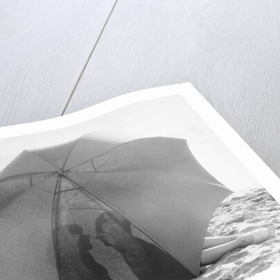 Couple on Beach Under Umbrella by Anonymous