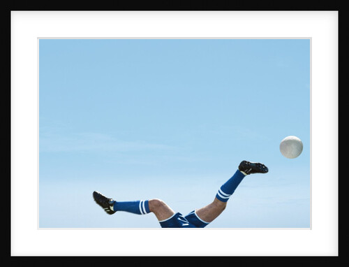 Soccer player upside-down attempting to kick the ball by Anonymous