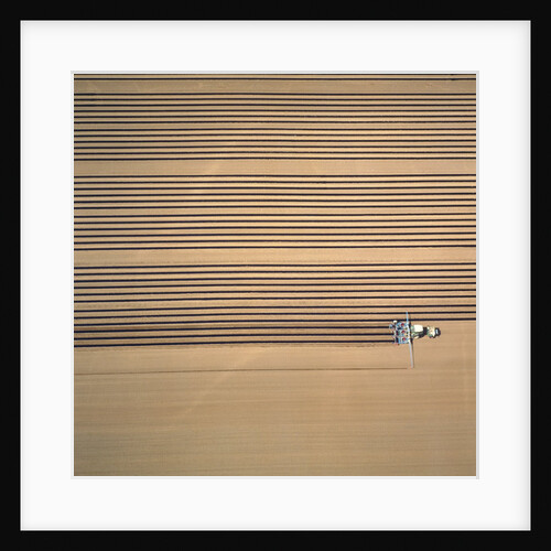 Aerial shot of a tractor cultivating by Anonymous