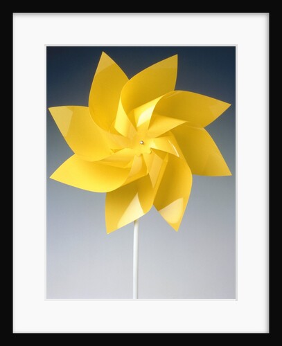Toy wind wheel in front of a gray background by Anonymous