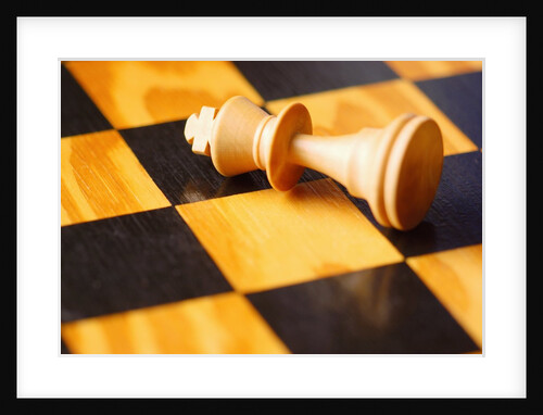 King chess piece lying on chessboard by Anonymous