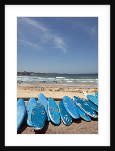 View of stacked up surfboards at the beach by Anonymous