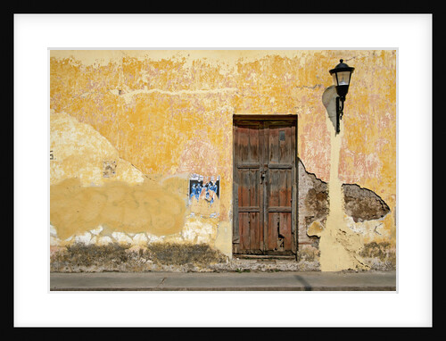 Broken Plaster on Yellow Wall with Old Wood Door by Anonymous
