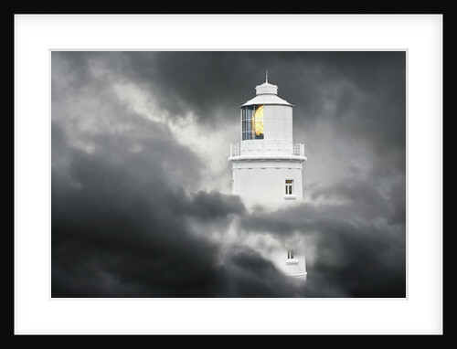 Lighthouse Emerging From Dark Clouds by Anonymous