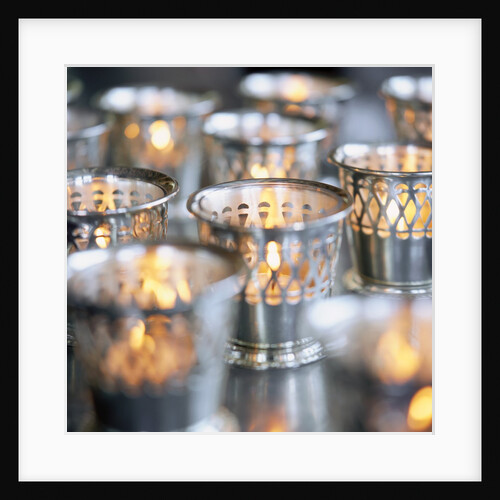 Many Votive Candles in Silver Holders by Anonymous