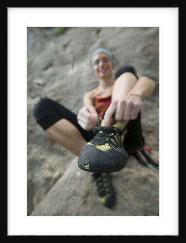Woman Putting on Rock Climbing Shoes by Anonymous