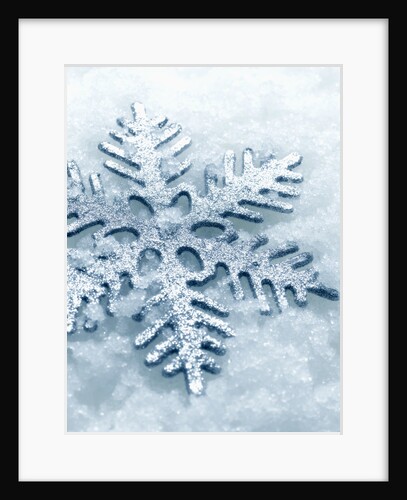 Snowflake Shaped Christmas Ornament Lying in the Snow by Anonymous
