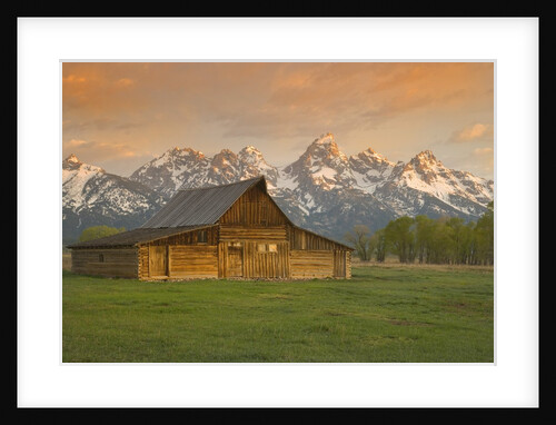 Log Barn in Meadow near Mountain Range by Anonymous