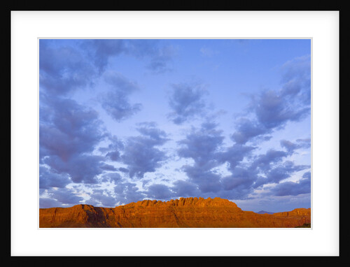 Cumulus Clouds Over Sandstone Buttes at Sunrise by Anonymous