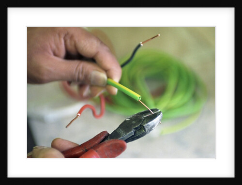 Electrician Stripping Electrical Wire by Anonymous