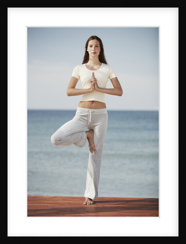 Woman doing yoga by the ocean by Anonymous