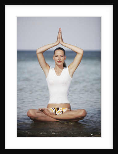 Woman meditating in the ocean by Anonymous