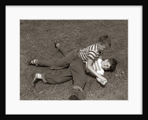 1950s Two Boys Wear Tee Shirts Blue Jeans Playing Rough Fighting Wrestling On The Grass by Anonymous