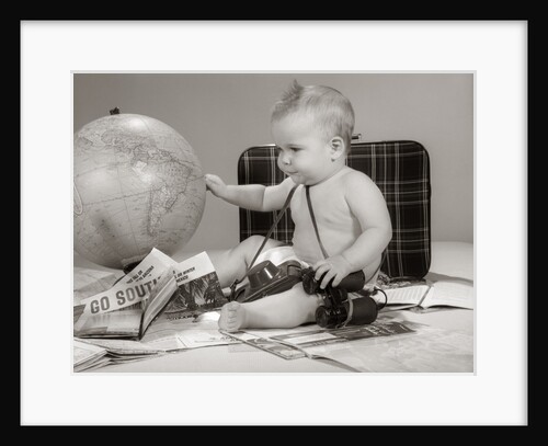 1960s Baby Seated Looking At Globe With Camera Binoculars Suitcase and Travel Brochures by Anonymous