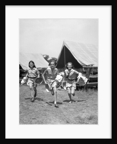 1930s Three Teen Girls Wearing Camp Shorts and Shirts Running From Tents While Holding Towels and Wash Basins by Anonymous