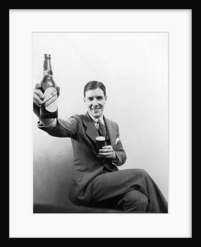 1920s 1930s Man Holding Up Huge Distorted Beer Bottle In One Hand And A Regular Size Glass Of Beer In Other by Anonymous