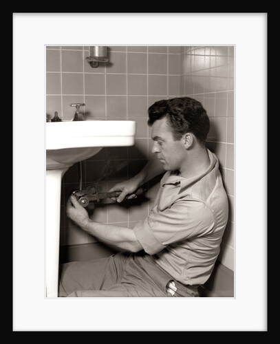 1950s Man Plumber Fixing Bathroom Sink by Anonymous