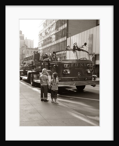 1970s 2 Children Boy Girl Holding Hands Looking At Fire Truck Parked On Street New York City by Anonymous