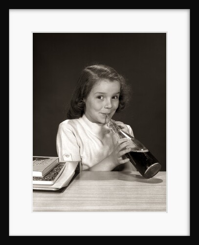 1950s 1960s School Girl Using Straw Drinking Carbonated Beverage From Bottle by Anonymous