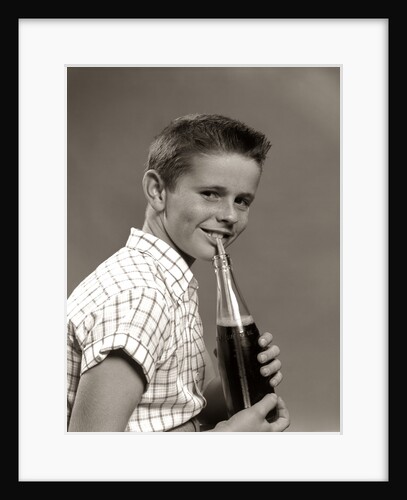 1950s Boy Drinking Carbonated Beverage From Soda Pop Bottle With Straw by Anonymous