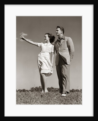 1940s Teenage Couple Standing Together Outdoors Girl Pointing by Anonymous