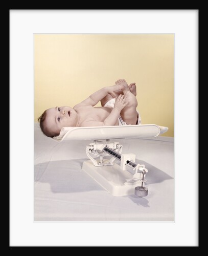 1950s 1960s Baby Lying On Weight Scale by Anonymous