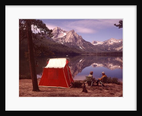 1970s Elderly Couple Camping Sitting By Red Tent Stanley Lake Idaho by Anonymous