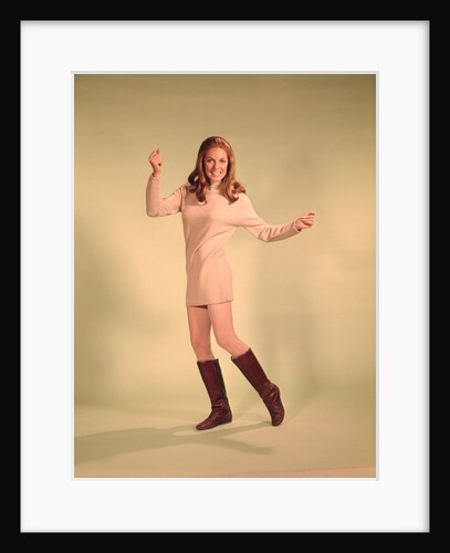 1960s Woman Dancer In Tan Dress And Boots White Fishnet Stockings by Anonymous