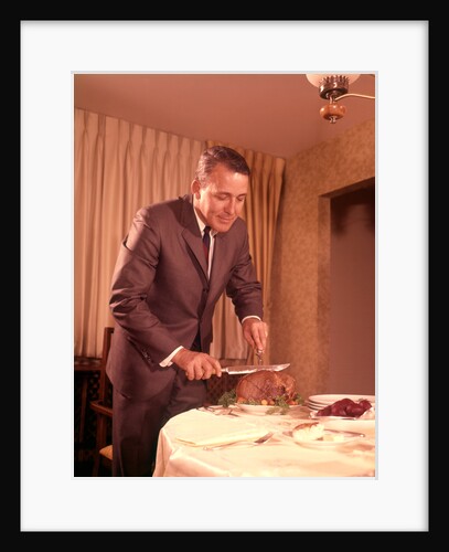 1960s Well-Dressed Man Carving Roast Beef At Dinner Table by Anonymous