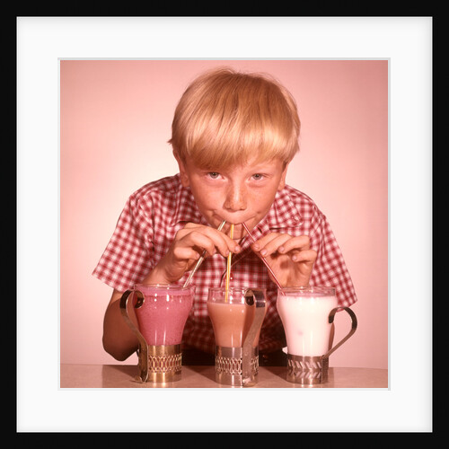 1950s 1960s Boy Drinking Three Milkshakes Through A Straw At Same Time by Anonymous