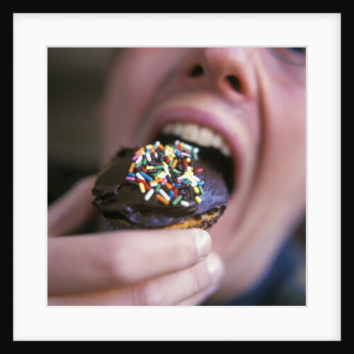 Man Eating Cupcake with Chocolate Frosting by Anonymous
