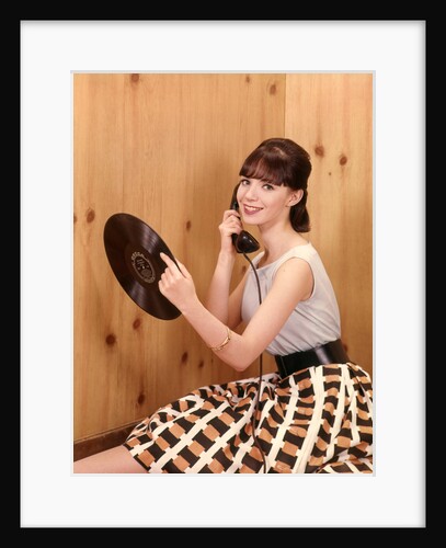 1950s Teenage Girl Talking On Telephone And Holding LP Record by Anonymous