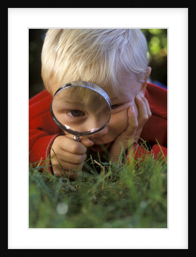 1980s Boy Using Magnifying Glass by Anonymous