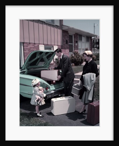 1950s Family Mother Father Daughter In Front Of Suburban House Packing Luggage In Car For Vacation by Anonymous