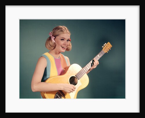 1960s Perky Young Teenager Folk Singer Playing Guitar by Anonymous