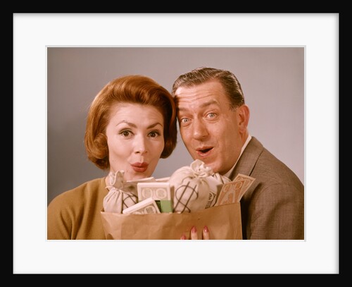 1960s Surprised Happy Couple Man Woman With Grocery Bag Filled With Money by Anonymous
