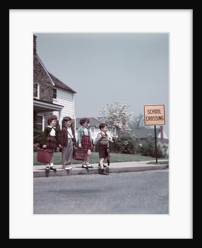 1950s Kids On Suburban Neighborhood Sidewalk About To Cross Street By School Crossing Sign by Anonymous