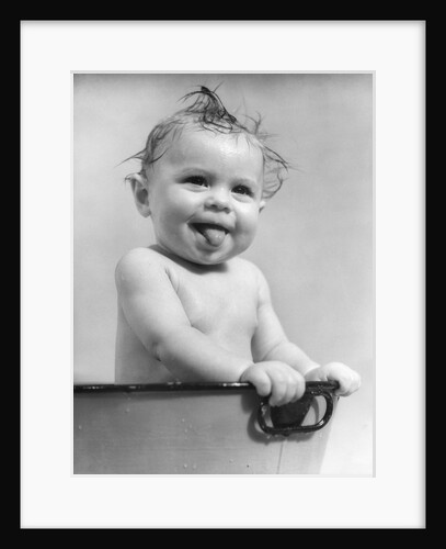 1940s 1930s Wet Baby Sitting In Tub Sticking Out Tongue by Anonymous